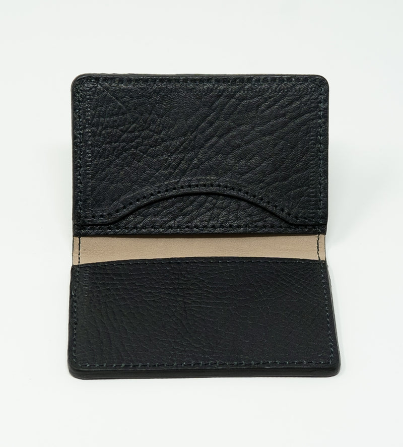 Black leather wallet with beige interior on a white background