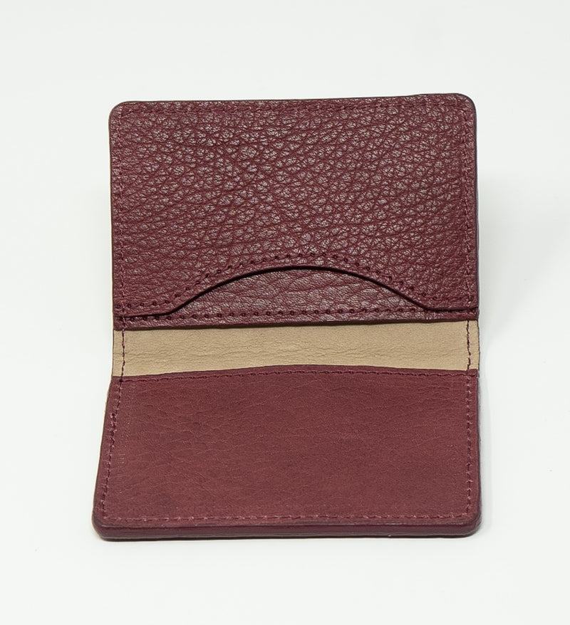 Burgundy leather wallet with beige stripe on a white background