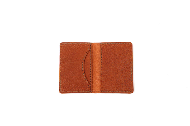 Open brown leather card wallet.